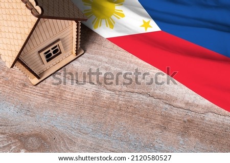 House model near Philippines flag. Real estate sale and purchase concept. Space for text.