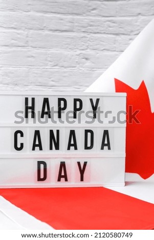 The National Flag of Canada. Lightbox with text HAPPY CANADA DAY Canadian Flag or the Maple Leaf. Patriotism. International relations concept. Independence day. Immigration