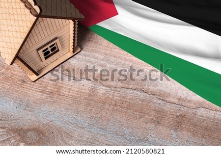 House model near Palestine flag. Real estate sale and purchase concept. Space for text.