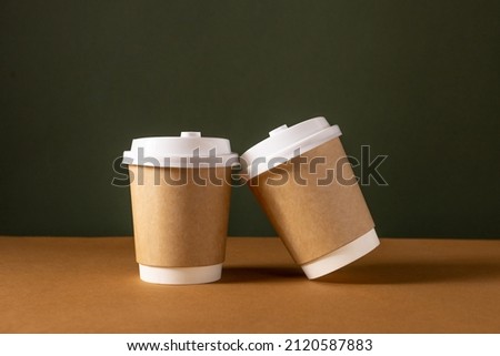 Coffee craft paper cups with place for logo on green and brown background, natural color, for menu and restaurants 