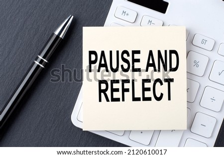 Text PAUSE AND REFLECT on sticker on calculator, business concept