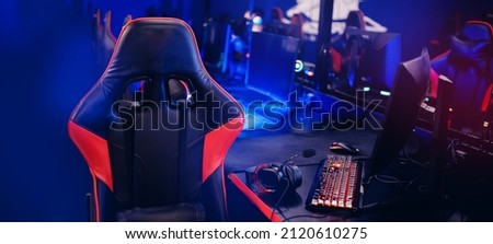 Banner Professional gamers cafe room with powerful personal computer game chair blue color. Concept cyber sport arena.