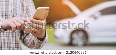 close up businessman hand using a mobile smart phone call a car mechanic ask for help assistance because car broken roadside. people journey friends standing wait beside broken car background. Royalty-Free Stock Photo #2120640836