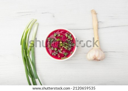 Borscht traditional beetroot soup, Ukrainian and Russian national cuisine. served in white bowl on wooden board. Top view, flat lay,