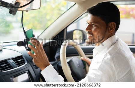 Cab driver using map navigation or gprs on mobile phone for travelling - cocnept of technology, smartphone and internet Royalty-Free Stock Photo #2120666372