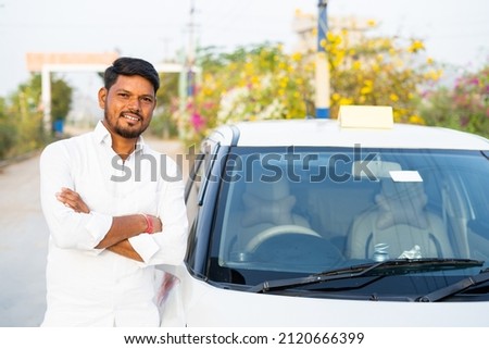Happy confident cab driver with crossed arms standing next to car by looking at camera - concept of self-employed, positive emotion and profesional occupation. Royalty-Free Stock Photo #2120666399
