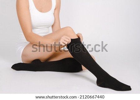 Medical Compression Stockings for varicose veins and venouse therapy. Compression Hosiery. Sock for sports isolated on white background. Black color socks mock up for advertising, branding, design.
