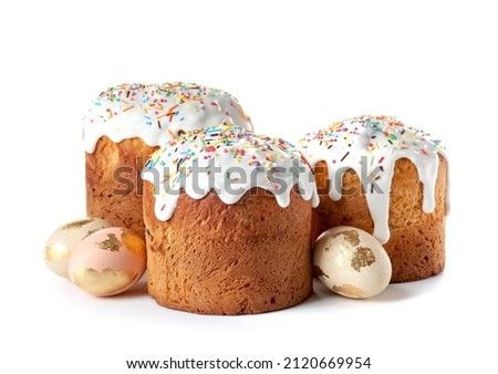 Delicious Easter cakes and eggs on white background Royalty-Free Stock Photo #2120669954