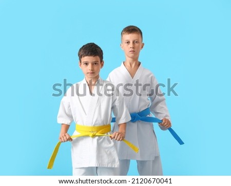 Little boys in karategi on color background Royalty-Free Stock Photo #2120670041