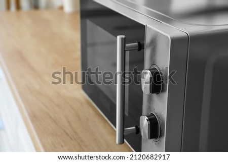 Modern microwave oven on counter in kitchen, closeup