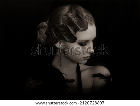 Hollywood. Style 20s or 30s. Young luxury Woman in Retro. Old-fashioned makeup and finger wave hairstyle. Vintage style. Feather boa. Mysterious Luxurious Girl. Finger wave hairstyle. Luxurious Woman