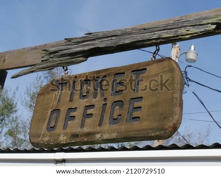 Wooden sign to a ticket office at a park