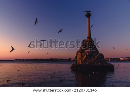 View of monument to sunken ships in Black sea water on sunset. Sevastopol, Crimea Royalty-Free Stock Photo #2120731145