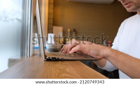 male freelancer works at a laptop in a cafe