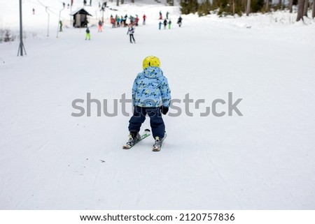 Little toddler boy, preschool child, skiing for the first time on small ski slope