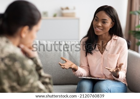 Psychotherapy Concept. Black psychologist lady talking to soldier woman during individual therapy, professional african american therapist counseling depressed military female, selective focus Royalty-Free Stock Photo #2120760839