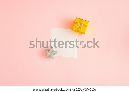 Chinese New Year Square leaflet mock up blank template design idea. Golden gift and silver star mockup against pastel pink background. Copy space templates designs for message layout.