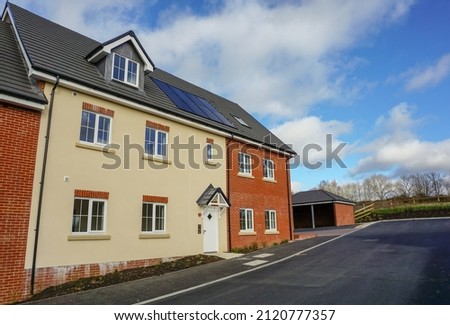 New build housing in UK. Fresh newly built homes on purpose built housing estate. Mortgage and house price concept.  Royalty-Free Stock Photo #2120777357