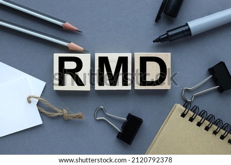 RMD. on wooden cubes text on wooden blocks. on a gray background.