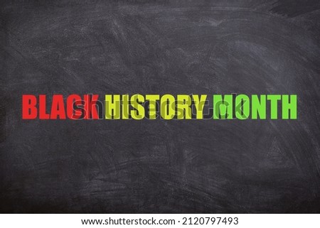 Black history month text in three different colors with a blackboard background. This image is about Black history month, equality, freedom, no racism, and African and American people's culture.