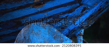 A fragment of the old blue wooden boat, texture, close-up. Panoramic image, graphic resources