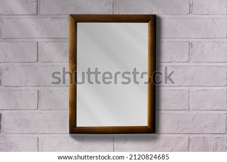 Photo frame on a brick wall. Clean background.