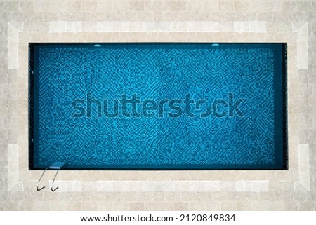 top view of a beautiful idyllic rectangular swimming pool with blue mosaic at the bottom Royalty-Free Stock Photo #2120849834