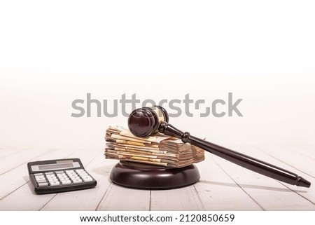 Compensation and judge's gavel. Award of moral financial compensation for caused damage. Lawyer services. Workers rights protection. Raising wages. Determination of payments by a court order. Royalty-Free Stock Photo #2120850659