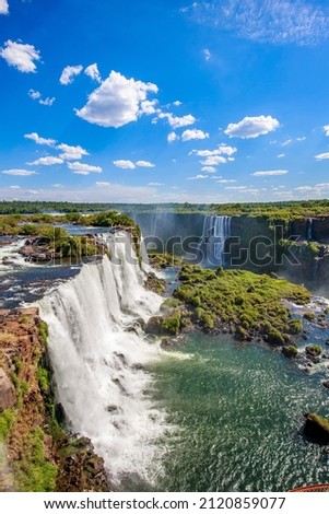 View of the Iguazu Falls, border between Brazil and Argentina. The falls are one of the seven wonders of the world and are located in the Iguaçu National Park, a UNESCO World Heritage Site. Royalty-Free Stock Photo #2120859077