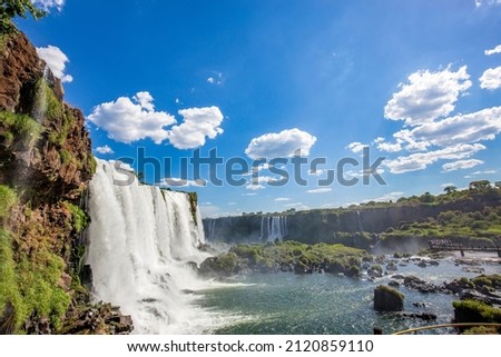 View of the Iguazu Falls, border between Brazil and Argentina. The falls are one of the seven wonders of the world and are located in the Iguaçu National Park, a UNESCO World Heritage Site. Royalty-Free Stock Photo #2120859110