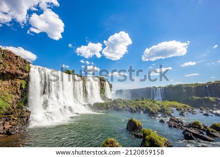View of the Iguazu Falls, border between Brazil and Argentina. The falls are one of the seven wonders of the world and are located in the Iguaçu National Park, a UNESCO World Heritage Site. Royalty-Free Stock Photo #2120859158