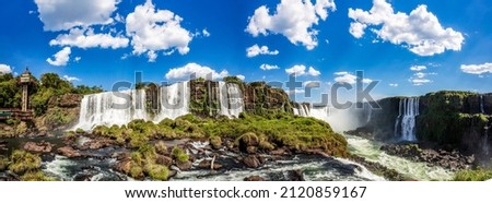 Panoramic view of the Iguazu Falls, border between Brazil and Argentina. The falls are one of the seven wonders of the world and are located in the Iguaçu National Park, a UNESCO World Heritage Site. Royalty-Free Stock Photo #2120859167