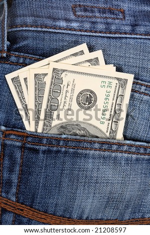 100 dollar bill sticking out from a blue jean pocket