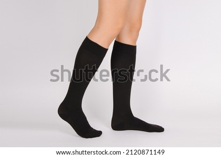 Medical Compression Stockings for varicose veins and venouse therapy. Compression Hosiery. Sock for sports isolated on white background. Black color socks mock up for advertising, branding, design. Royalty-Free Stock Photo #2120871149