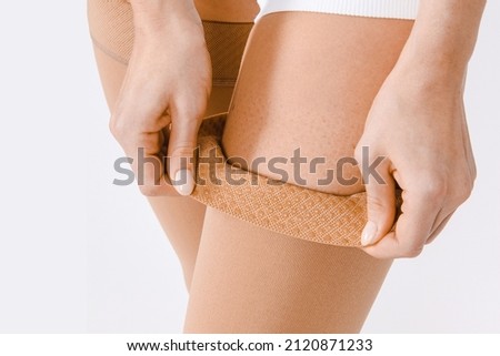 Compression Hosiery. Medical Compression stockings and tights for varicose veins and venouse therapy. Socks for man and women. Clinical compression knits. Comfort maternity tights for pregnant women. Royalty-Free Stock Photo #2120871233