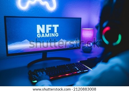 Young gamer buying NFT with token on marketplace platform for metaverse video game - Crypto technology trends - Focus on computer monitor