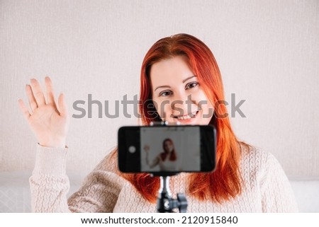 Young woman blogger influencer is recording video for her vlog. Modern businesswoman leading online stream. Social media concept, online courses.