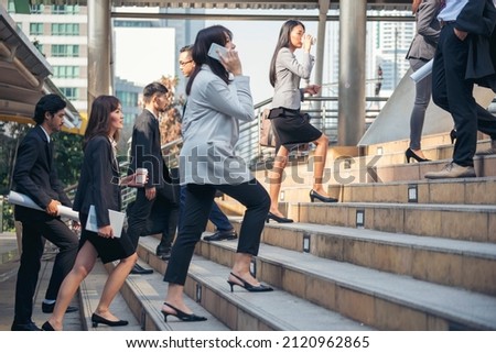 Busy asian people hurry city lifestyle. Crowd asian business people walking go to work in modern urban city office. Group of asian business people busy life urban street. Business People lifestyle Royalty-Free Stock Photo #2120962865
