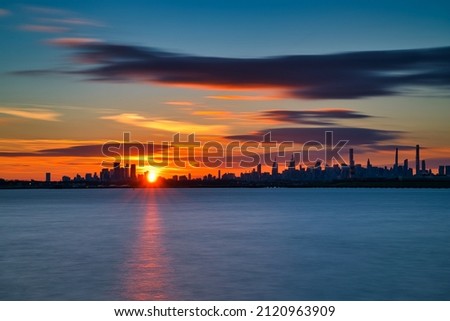 New York, NY, USA - Dec 26th 2021: sunset over Manhattan and Queens. Long exposure photo a sunset over Queens and Manhattan.  Photo was taken from MacNeil Park in College Pt. 