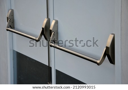 rear door of department store or warehouse with handle for quick release of door. evacuation door handle, panic fire button. in dangerous crush, all you have to do is lean horizontal pushing, push, Royalty-Free Stock Photo #2120993015