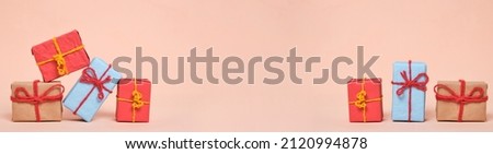 Banner, gifts packed in multicolored paper on pastel beige background.Concept Christmas holidays and eighth March in spring