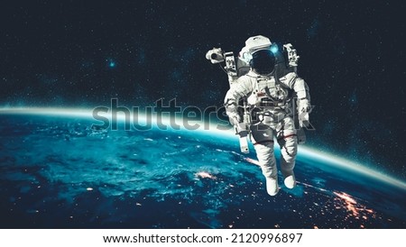 Astronaut spaceman do spacewalk while working for spaceflight mission at space station . Astronaut wear full spacesuit for operation . Elements of this image furnished by NASA space astronaut photos . Royalty-Free Stock Photo #2120996897