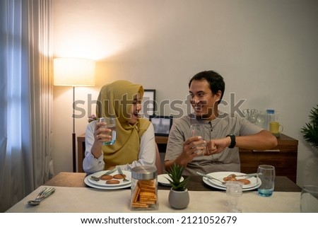 excited couple having iftar dinner time together Royalty-Free Stock Photo #2121052679