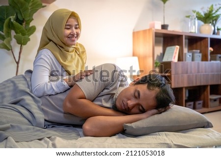 wife waking her husband up in the bed to have a breakfast Royalty-Free Stock Photo #2121053018