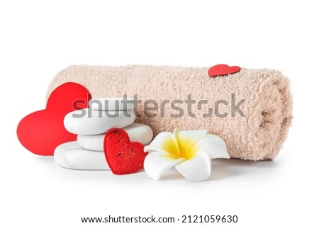 Spa stones, flower and towel isolated on white background. Valentine's Day celebration