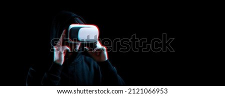 Vr glasses virtual reality. Blured young man in digital headset for virtual reality technology on dark background with glitch effect. Amazing technology, online game, entertainment.