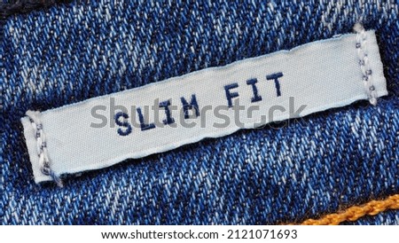 Close-up of textile label with the inscription slim fit