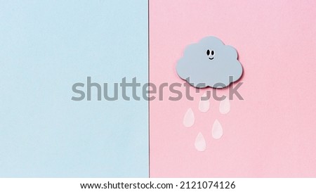 Small Handmade Toy in Shape of Clouds with Rain on Blue and Pink Background with Copy Space HandMade Toys Abstract Sky