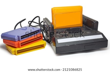 old TV game console. vintage game console with joypads. Stack of game cartridges near. isolated on white background. with clipping path