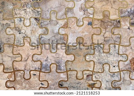 Old, faded and cracked wall puzzle collage with golden frames. Concrete, cement and golden wall pattern. Symmetric and abstract textured Background. 